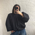 Blouse noire dos ouvert à manches bouffantes